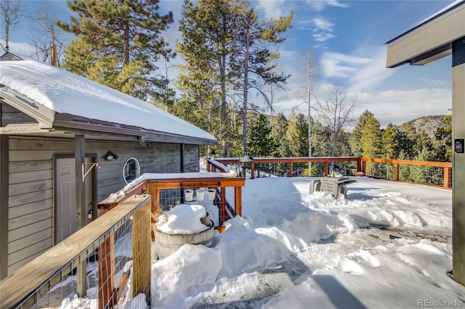 19273 Silver Ranch Road Conifer, CO 80433 - Photo 2 of 37 a view of balcony with wooden floor and fence