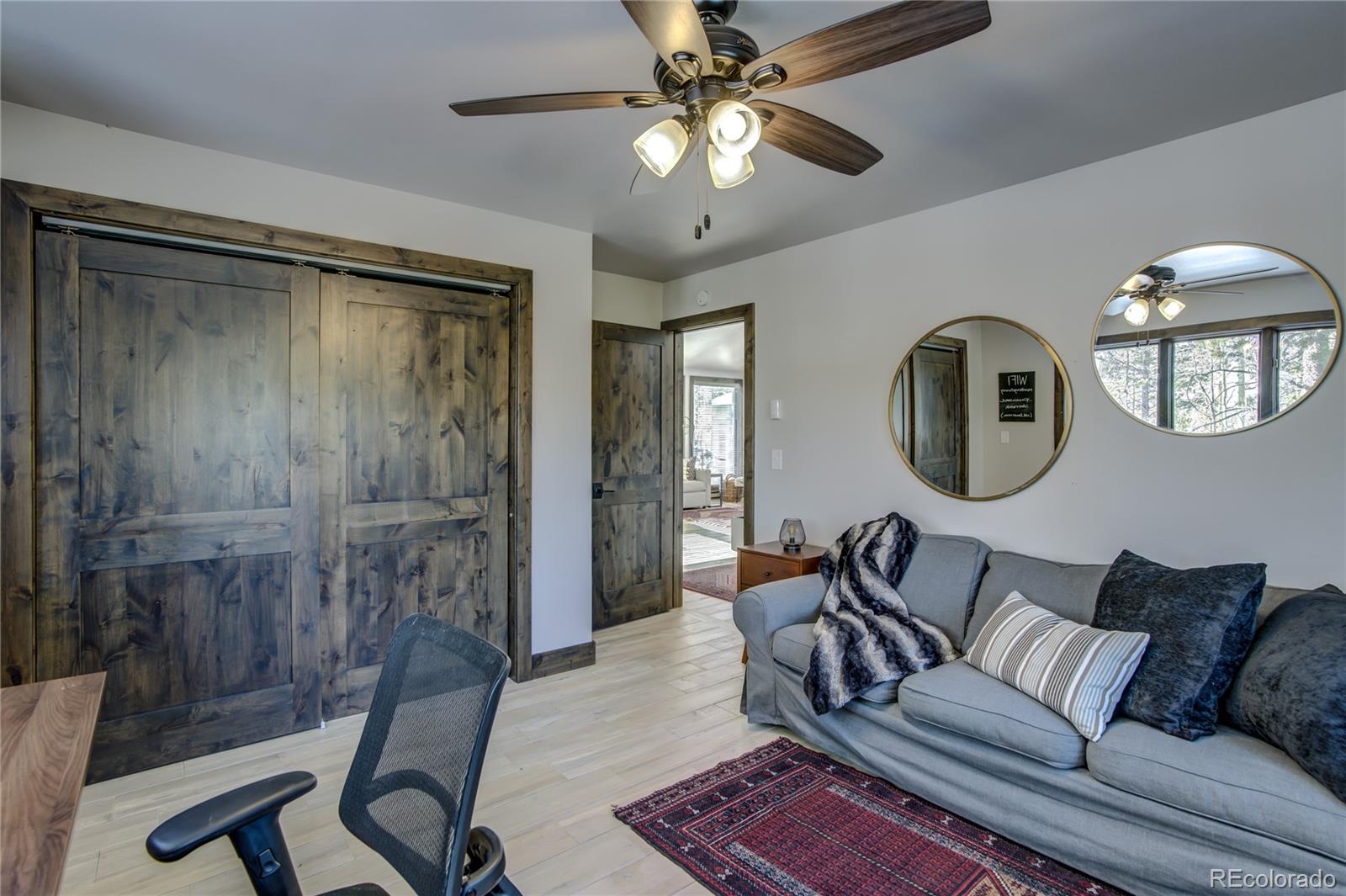 19273 Silver Ranch Road Conifer, CO 80433 - Photo 26 of 37 a living room with furniture and a mirror