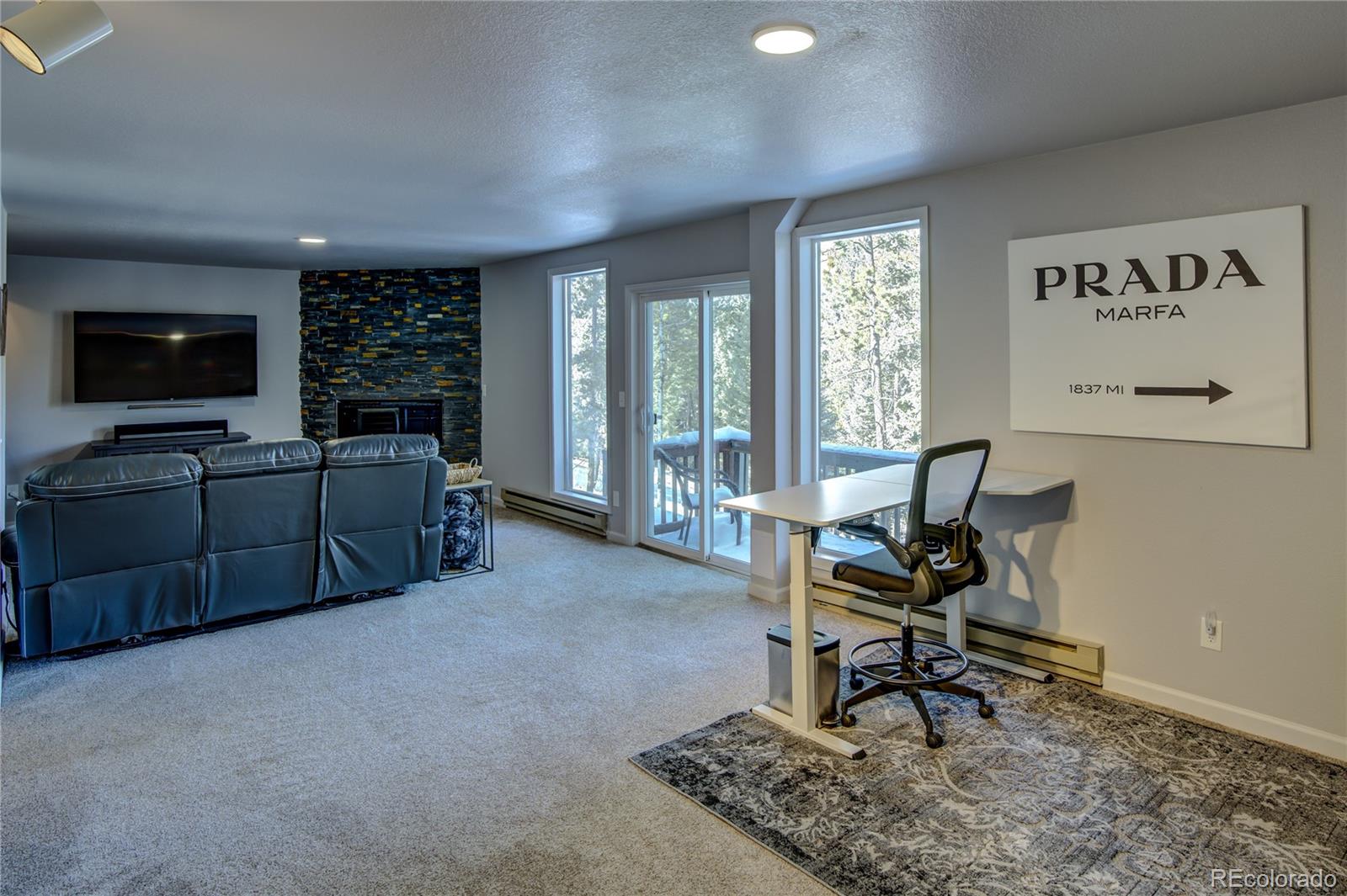 19273 Silver Ranch Road Conifer, CO 80433 - Photo 29 of 37 a living room with furniture and a flat screen tv