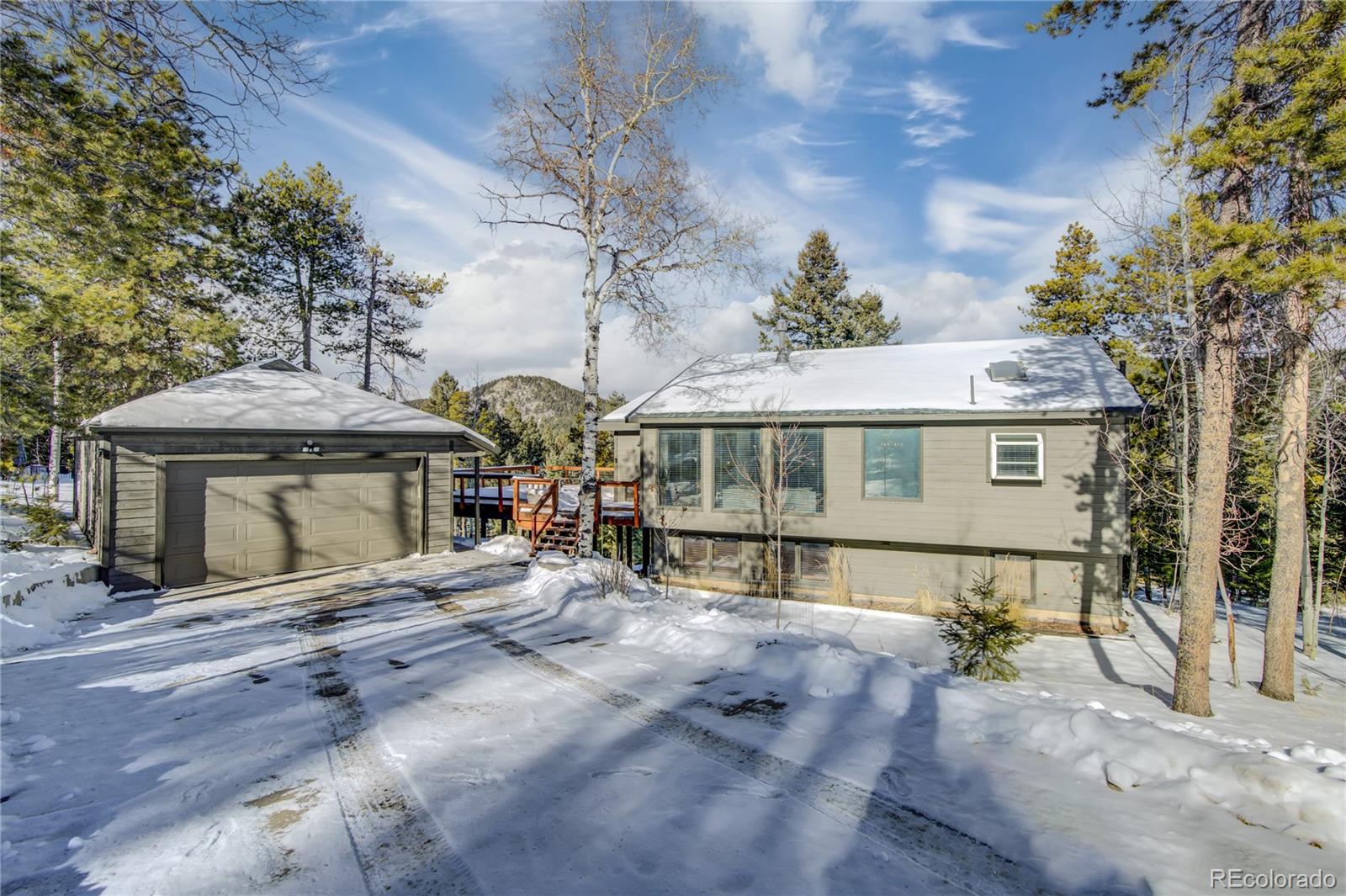 19273 Silver Ranch Road Conifer, CO 80433 - Photo 3 of 37 a front view of a house with a yard