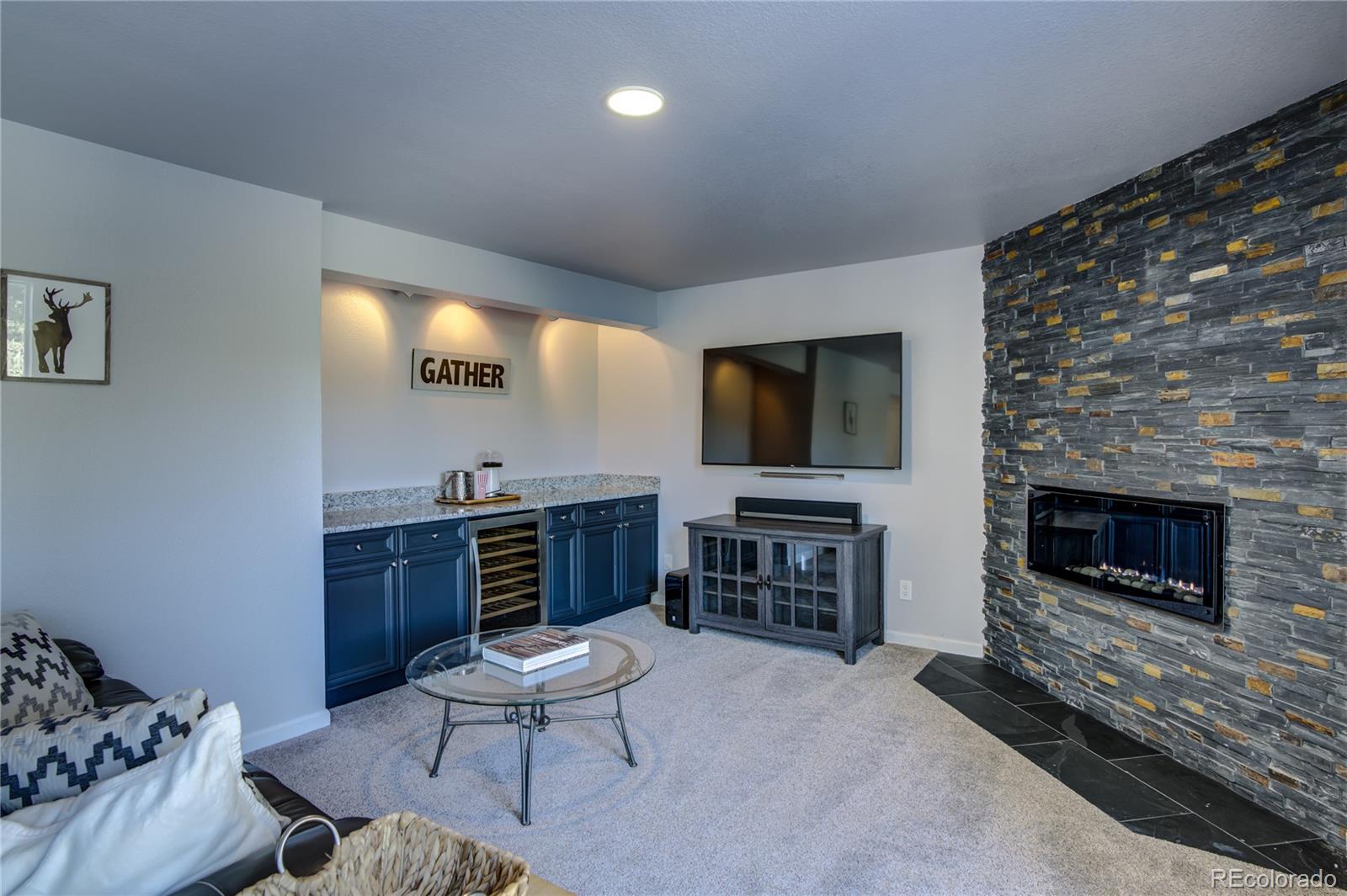 19273 Silver Ranch Road Conifer, CO 80433 - Photo 31 of 37 a living room with furniture and a flat screen tv