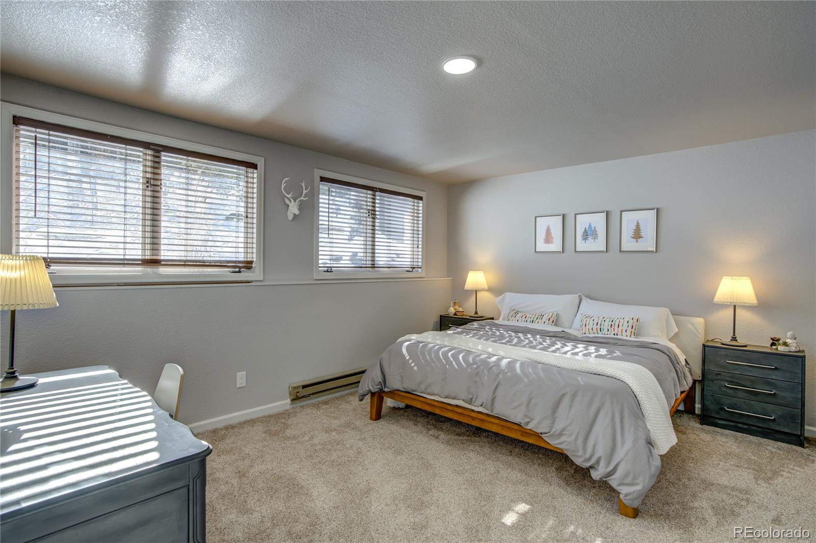 19273 Silver Ranch Road Conifer, CO 80433 - Photo 33 of 37 a bedroom with a bed and a lamp