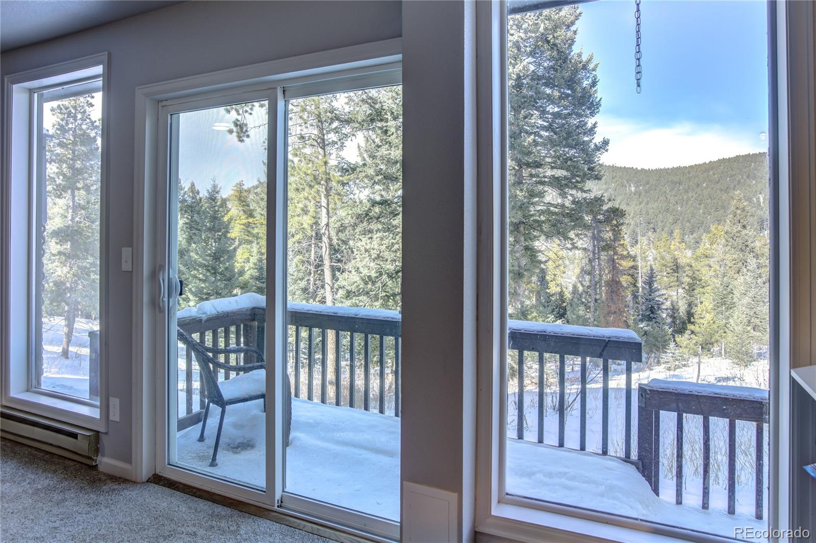 19273 Silver Ranch Road Conifer, CO 80433 - Photo 36 of 37 a view of a room with wooden floor and front door