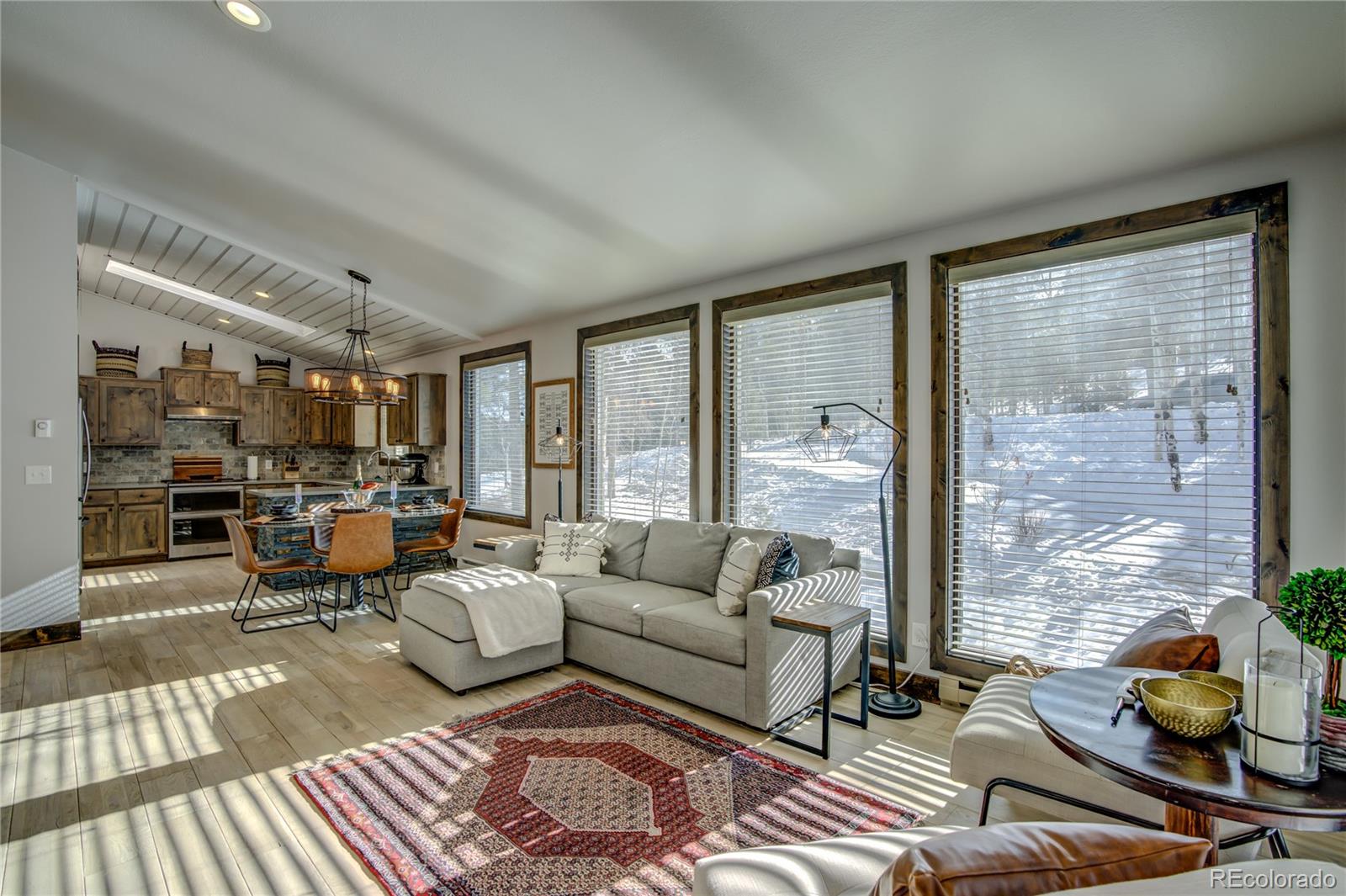 19273 Silver Ranch Road Conifer, CO 80433 - Photo 10 of 37 a living room with furniture and floor to ceiling windows