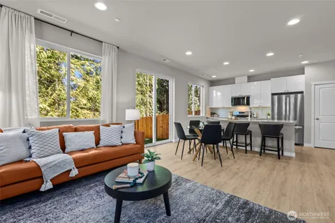 a kitchen with a table chairs refrigerator and cabinets