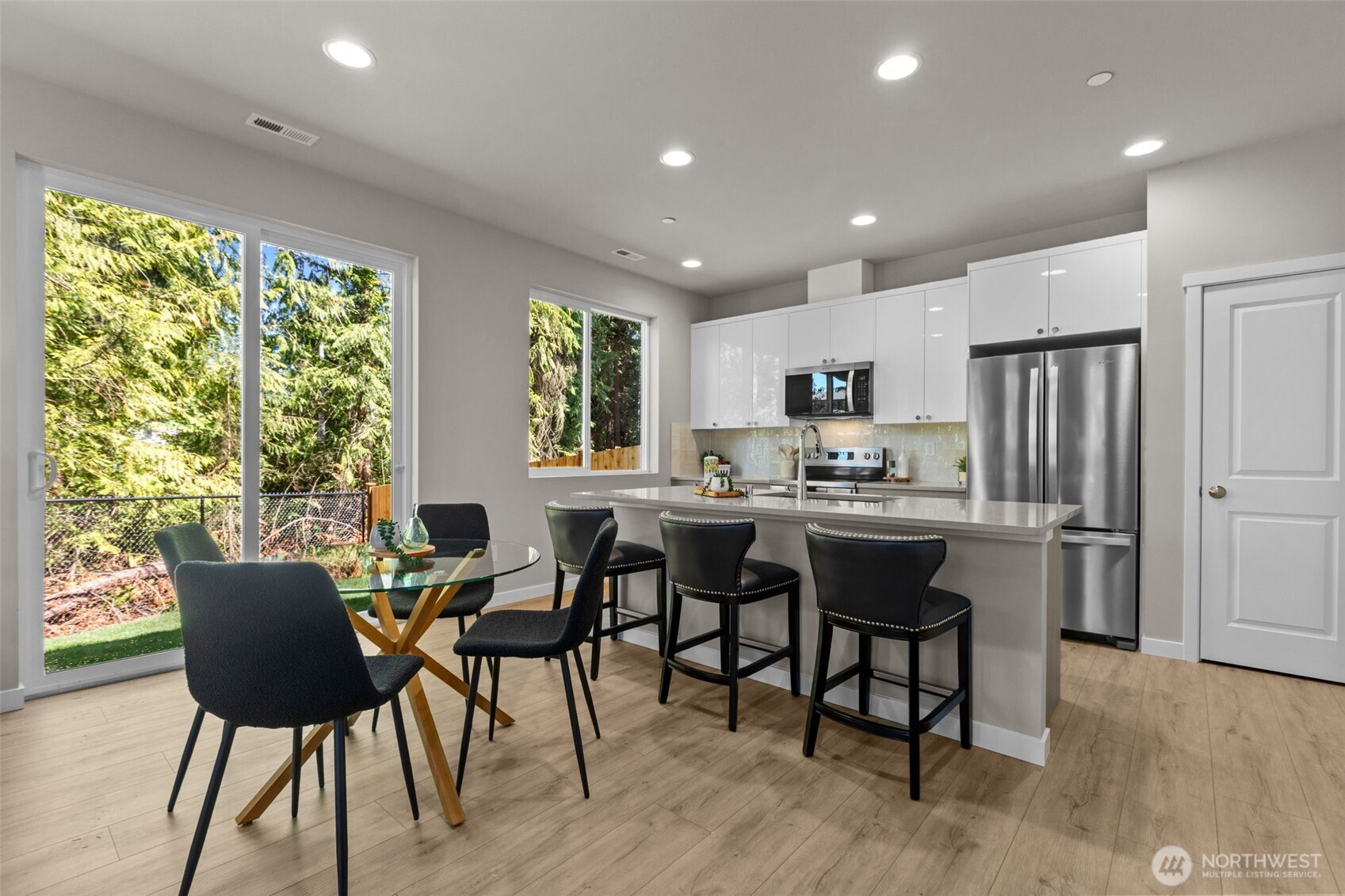 114 A 169th Place Southwest Bothell, WA 98012 - Photo 15 of 31 a kitchen with a table chairs refrigerator and cabinets