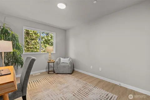 a bedroom with a bed and painting on the wall