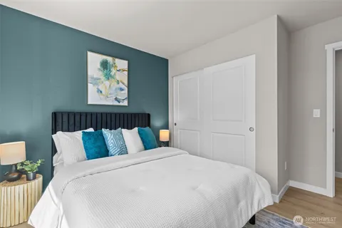 a bedroom with a bed and painting on the wall