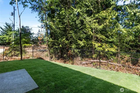 a view of a house with a backyard