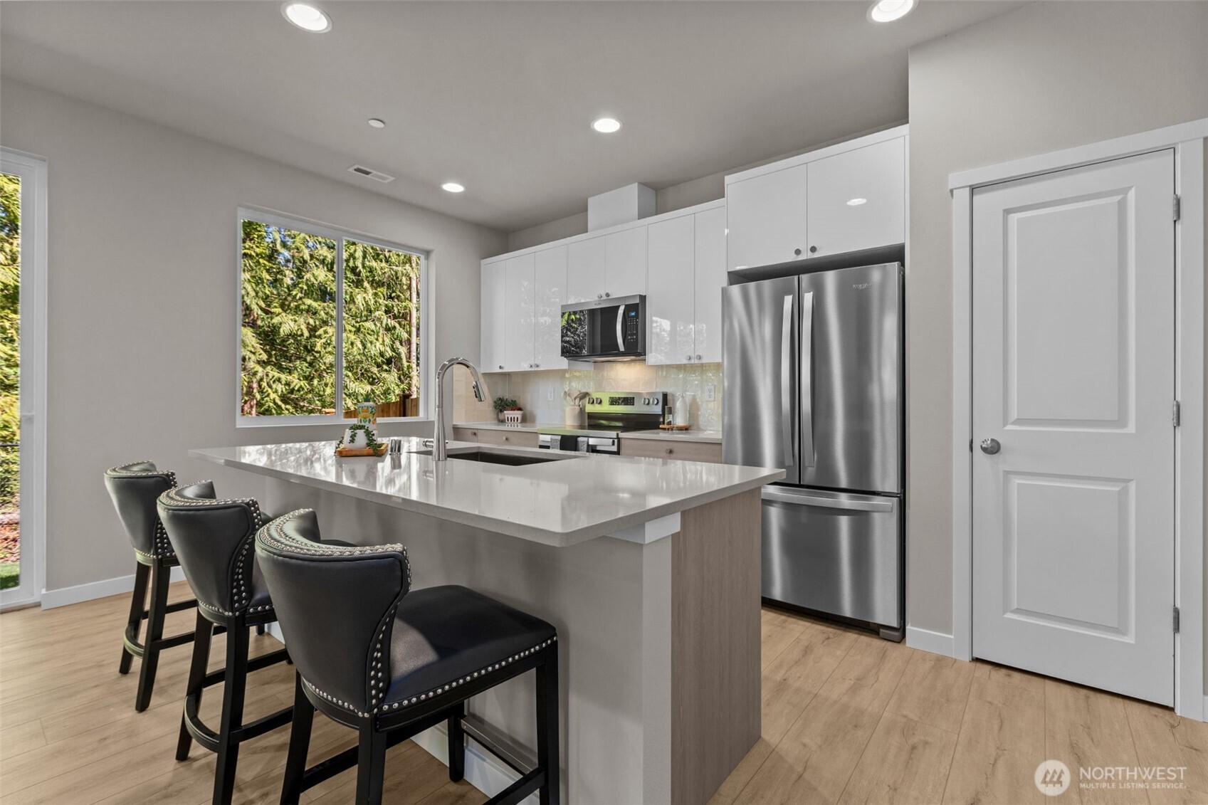 114 A 169th Place Southwest Bothell, WA 98012 - Photo 7 of 31 a kitchen with a refrigerator a table and chairs