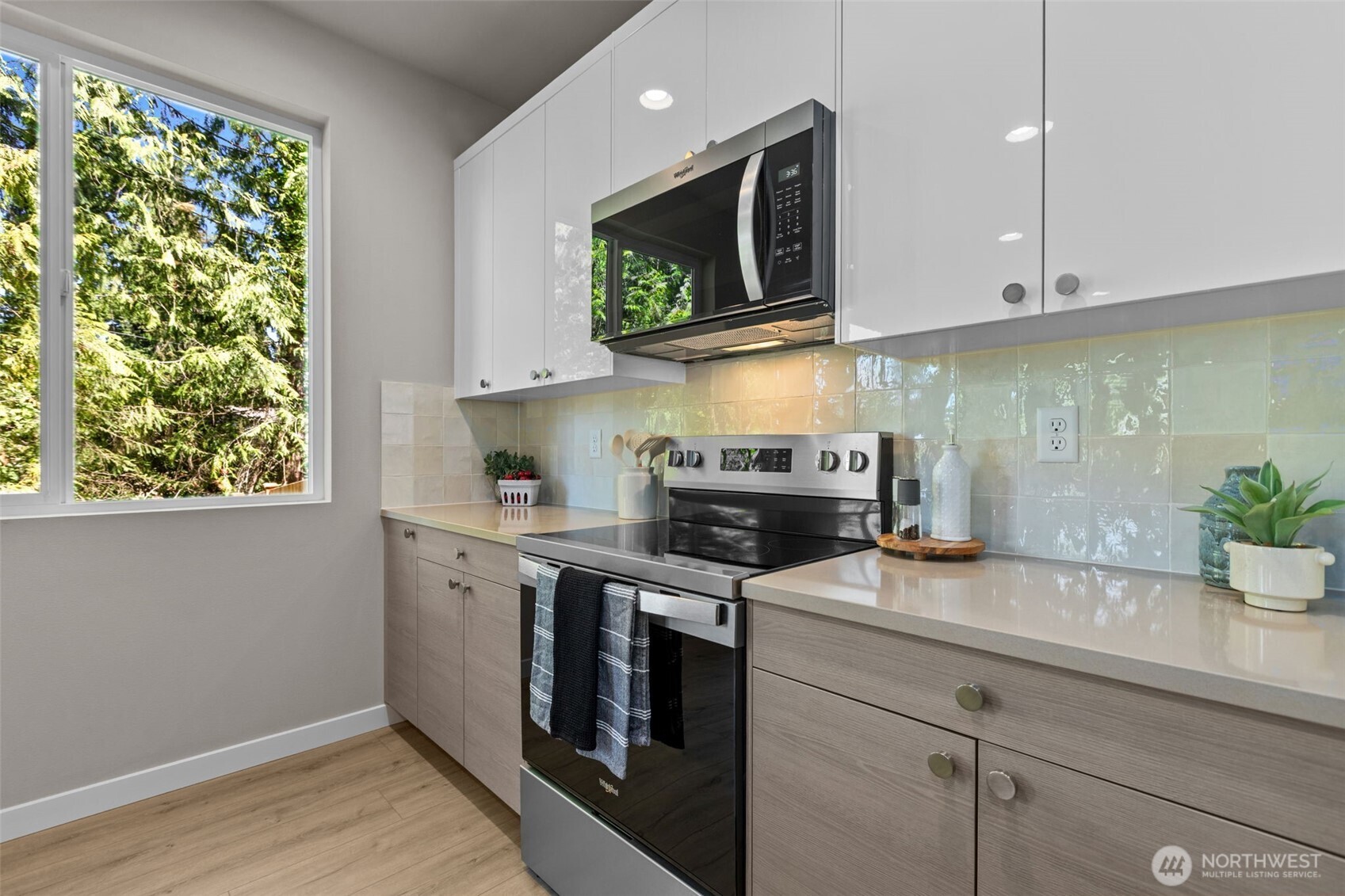 114 A 169th Place Southwest Bothell, WA 98012 - Photo 9 of 31 a kitchen with stainless steel appliances white cabinets and a stove top oven