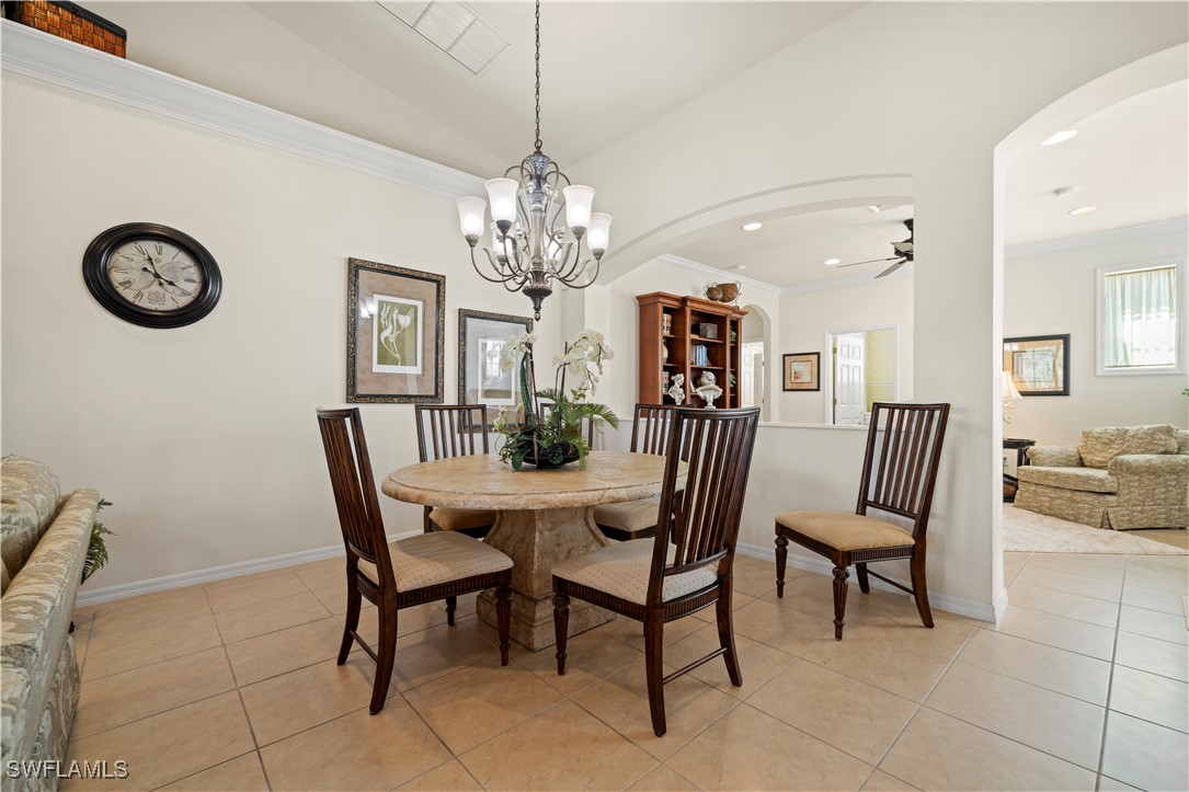 14941 Reflection Key Circle, Unit 621 Fort Myers, FL 33907 - Photo 12 of 42 a view of a dining room with furniture and chandelier