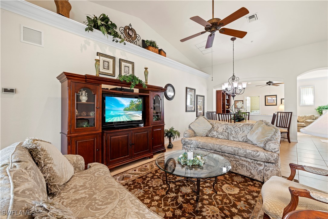 14941 Reflection Key Circle, Unit 621 Fort Myers, FL 33907 - Photo 14 of 42 a living room with furniture a ceiling fan and a flat screen tv