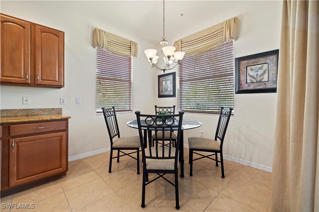 14941 Reflection Key Circle, Unit 621 Fort Myers, FL 33907 - Photo 17 of 42 a view of a dining room with furniture and chandelier