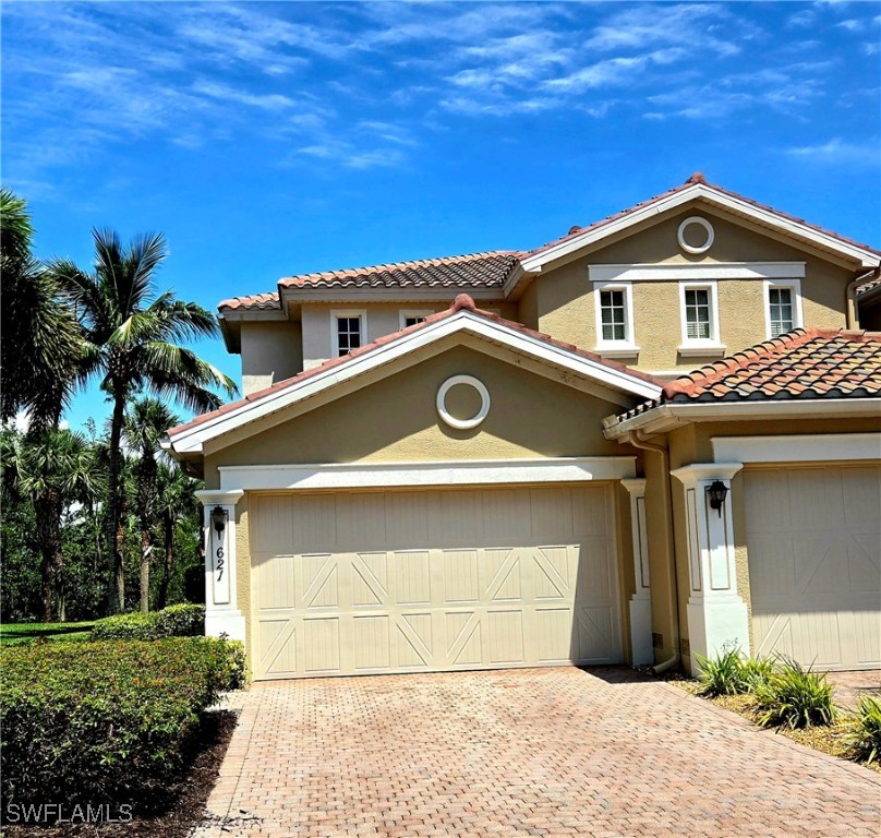 14941 Reflection Key Circle, Unit 621 Fort Myers, FL 33907 - Photo 2 of 42 a view of a house with a yard