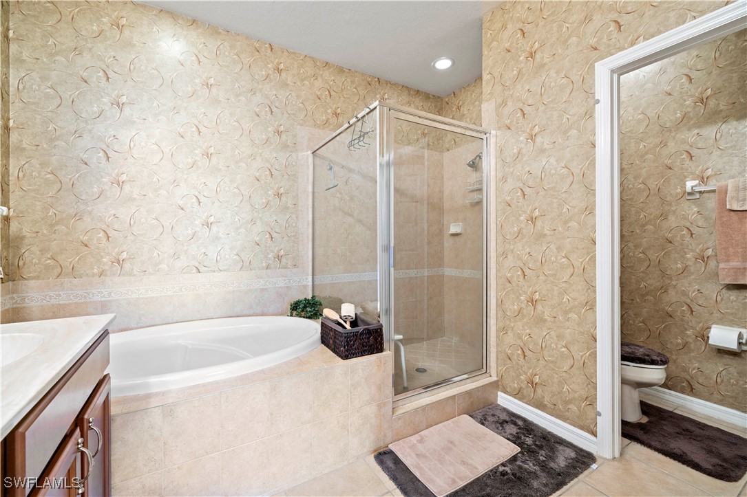 14941 Reflection Key Circle, Unit 621 Fort Myers, FL 33907 - Photo 21 of 42 a bathroom with a bathtub and a shower