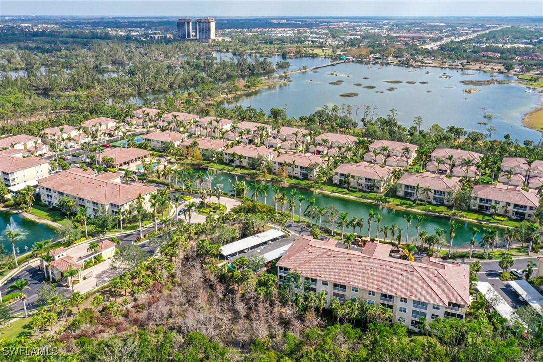 14941 Reflection Key Circle, Unit 621 Fort Myers, FL 33907 - Photo 31 of 42 an aerial view of lake and residential houses with outdoor space