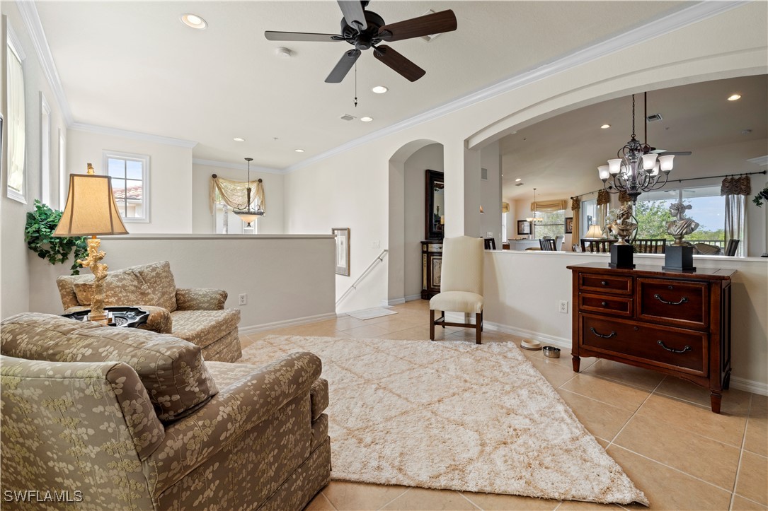 14941 Reflection Key Circle, Unit 621 Fort Myers, FL 33907 - Photo 7 of 42 a living room with furniture and a chandelier