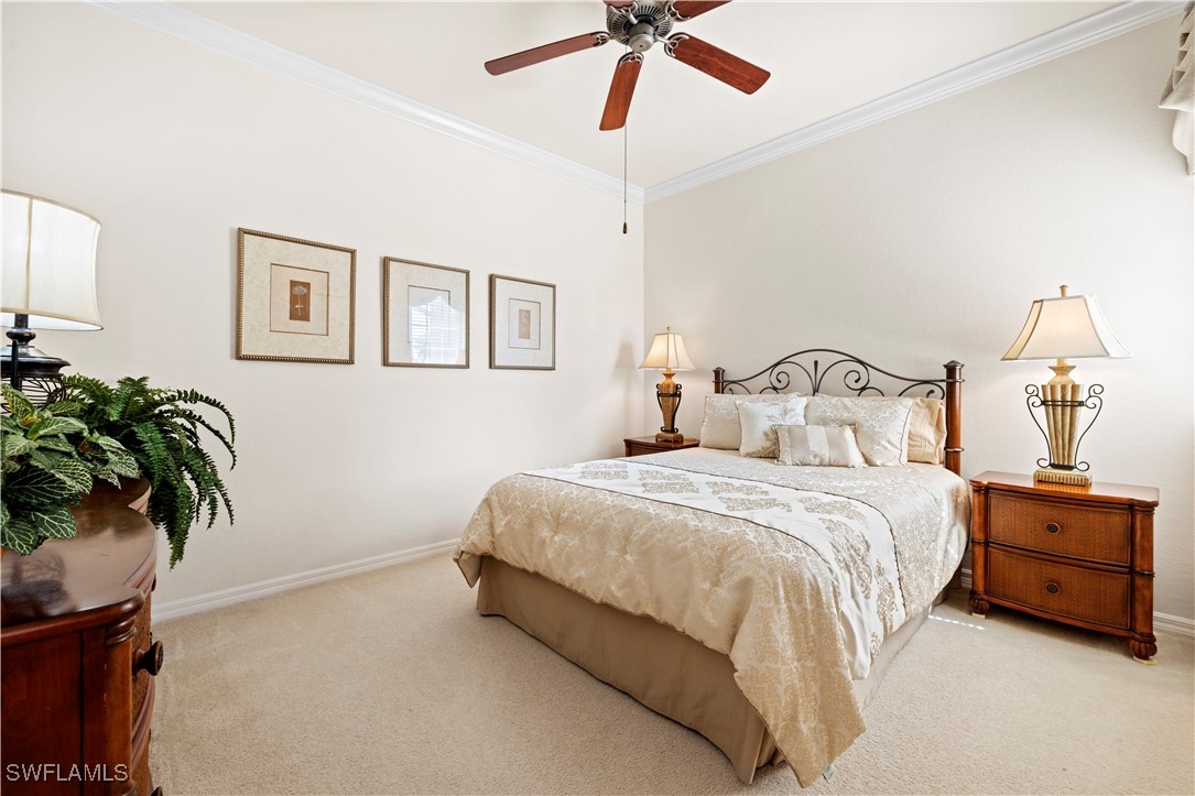 14941 Reflection Key Circle, Unit 621 Fort Myers, FL 33907 - Photo 8 of 42 a bedroom with a bed and a potted plant