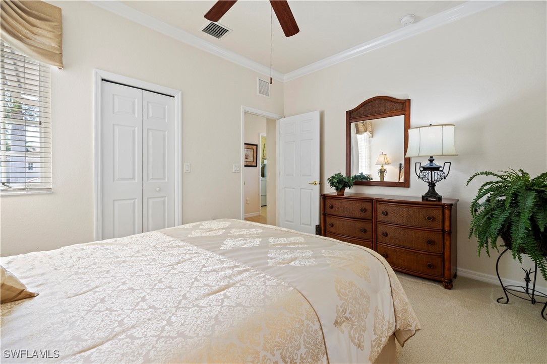 14941 Reflection Key Circle, Unit 621 Fort Myers, FL 33907 - Photo 9 of 42 a bedroom with a bed and a dresser