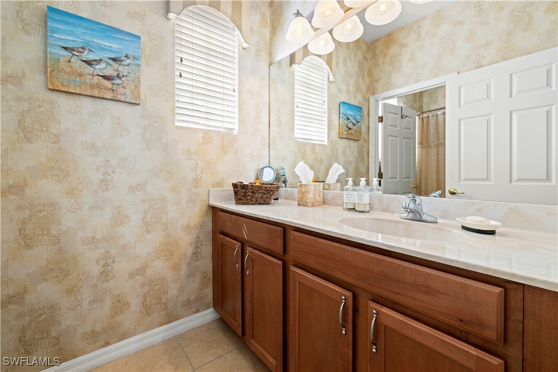14941 Reflection Key Circle, Unit 621 Fort Myers, FL 33907 - Photo 10 of 42 a bathroom with a sink and a mirror