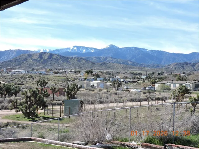 a living room with furniture kitchen view and a flat screen tv