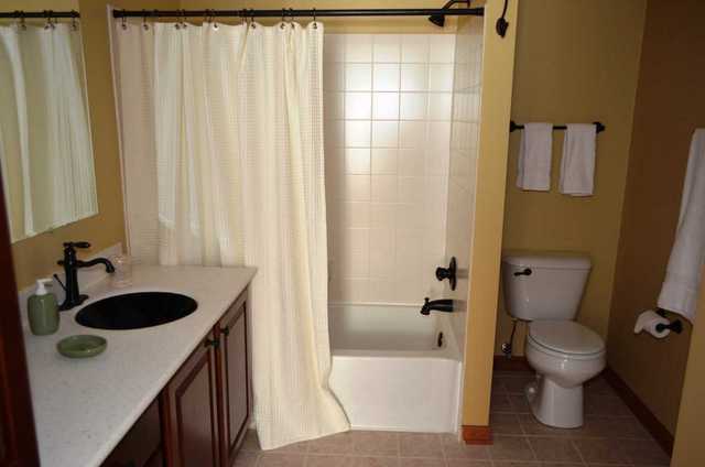 2548 Congress Avenue Aurora, IL 60503 - Photo 11 of 22 a bathroom with a granite countertop sink and a toilet