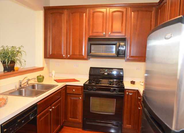 2548 Congress Avenue Aurora, IL 60503 - Photo 7 of 22 a kitchen with a sink a stove and cabinets