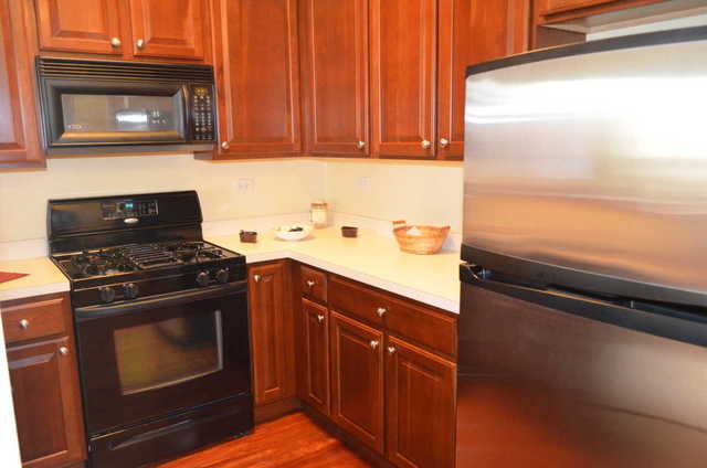 2548 Congress Avenue Aurora, IL 60503 - Photo 8 of 22 a kitchen with a stove and a microwave