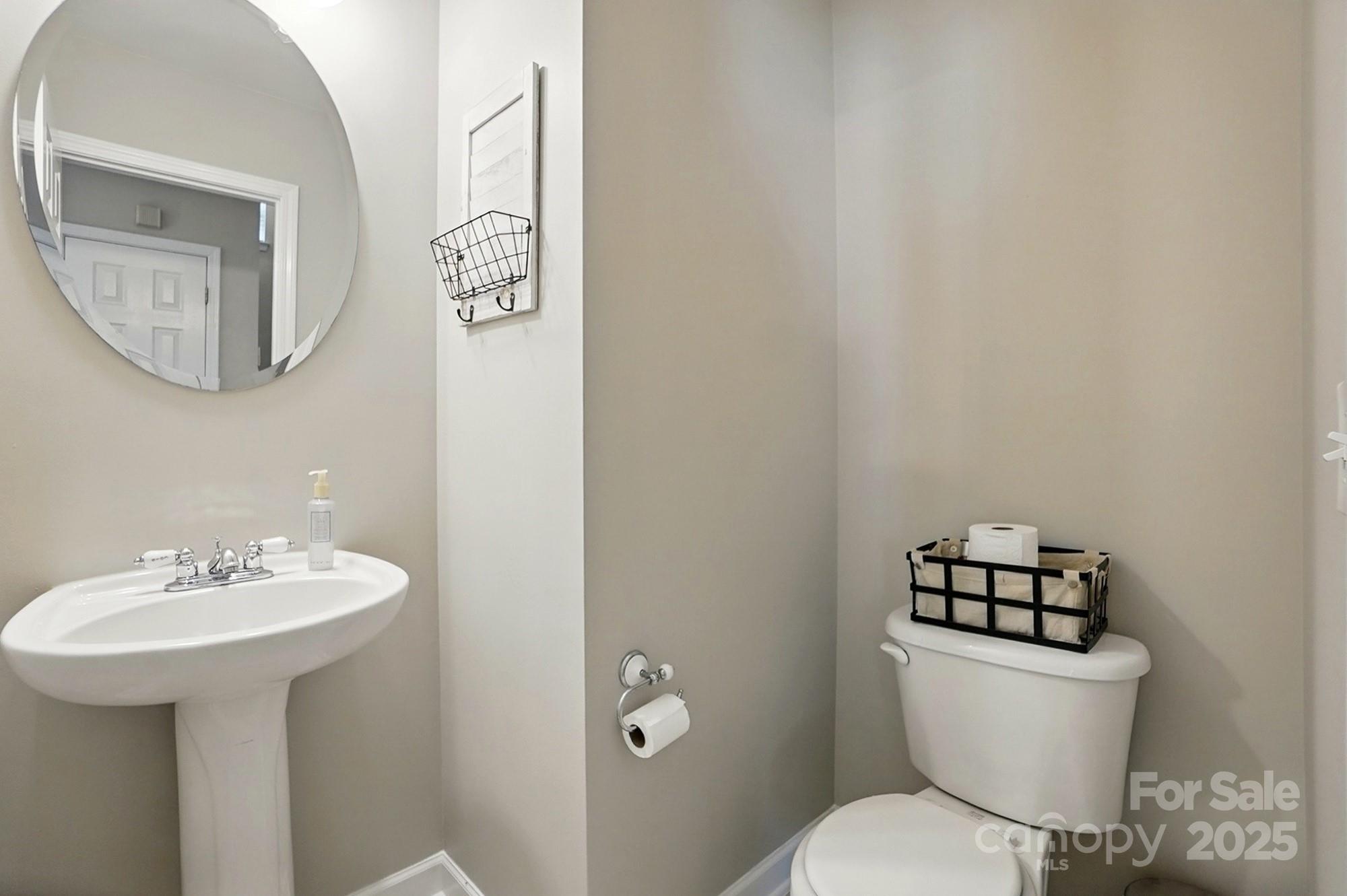 820 Settlement Street Clover, SC 29710 - Photo 11 of 29 a bathroom with a toilet a sink and mirror