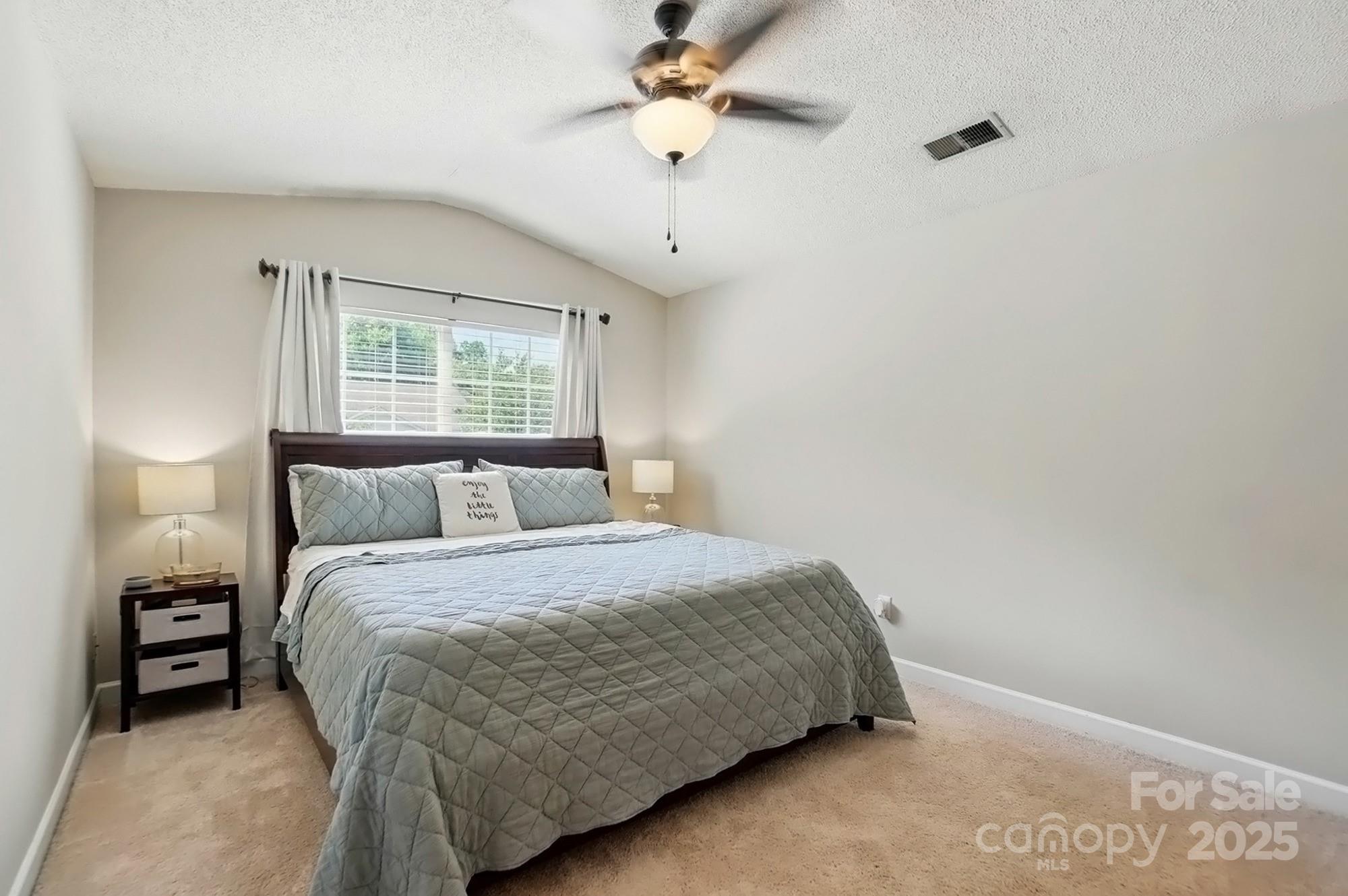820 Settlement Street Clover, SC 29710 - Photo 13 of 29 a bedroom with a bed and a chandelier
