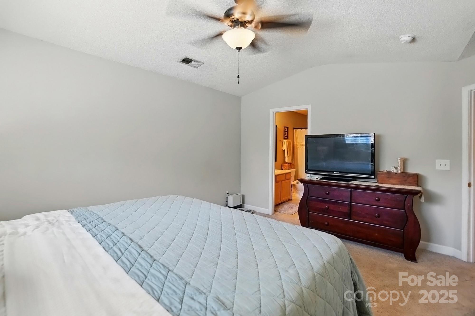820 Settlement Street Clover, SC 29710 - Photo 16 of 29 a bedroom with a bed and a flat screen tv