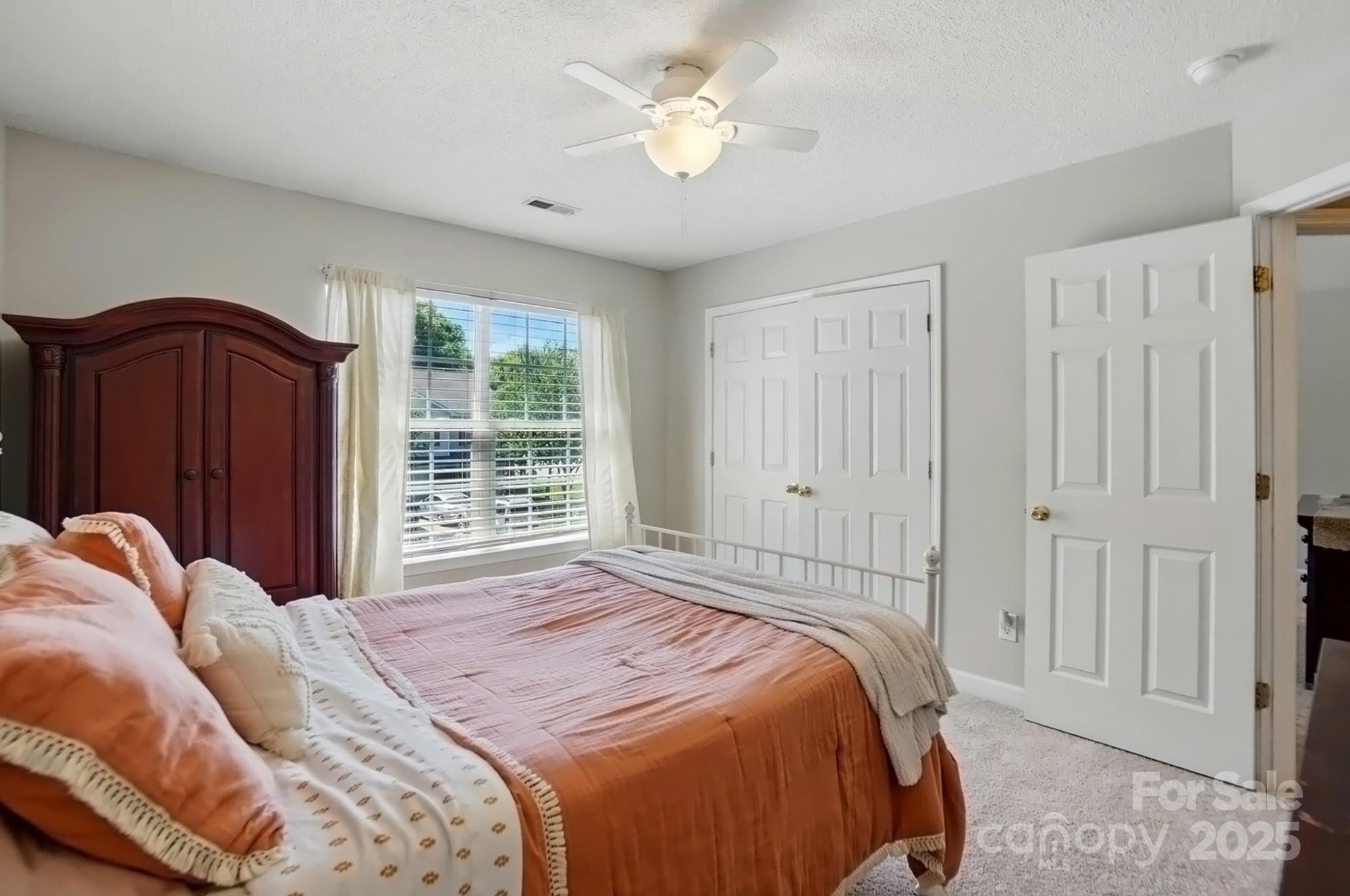 820 Settlement Street Clover, SC 29710 - Photo 19 of 29 a bedroom with a bed and a chandelier