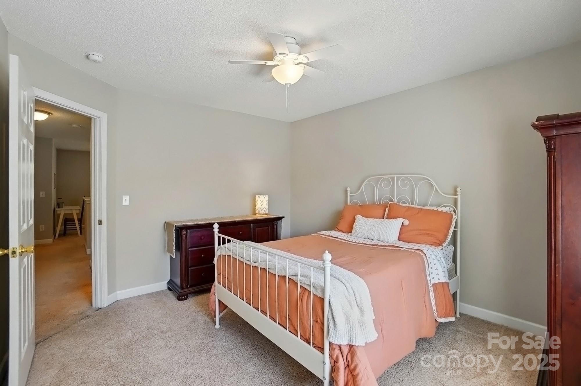 820 Settlement Street Clover, SC 29710 - Photo 20 of 29 a bedroom with a bed and a chandelier