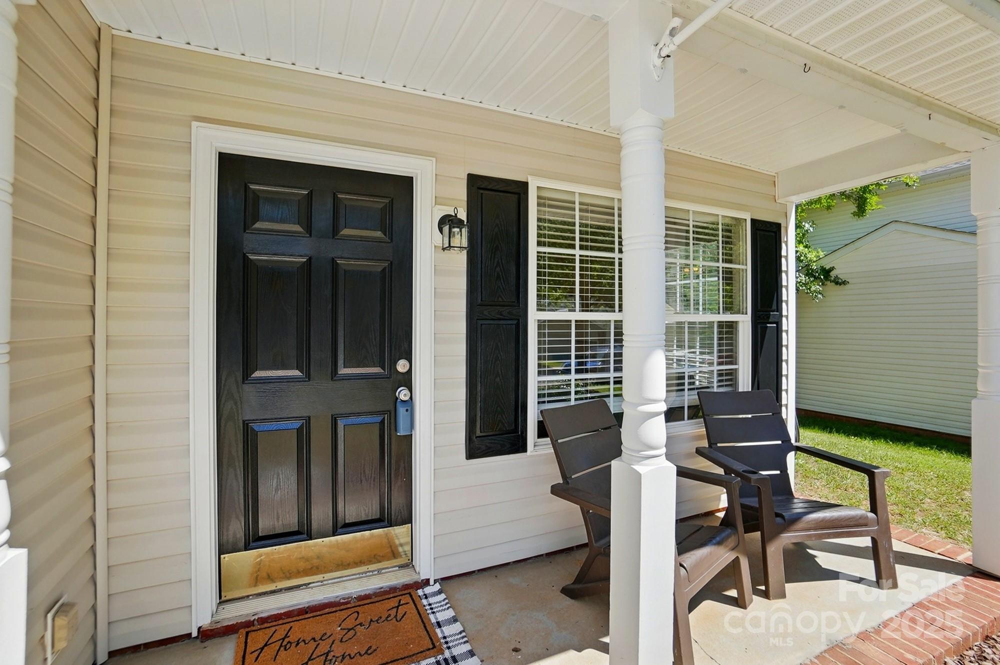 820 Settlement Street Clover, SC 29710 - Photo 2 of 29 a balcony with table and chairs