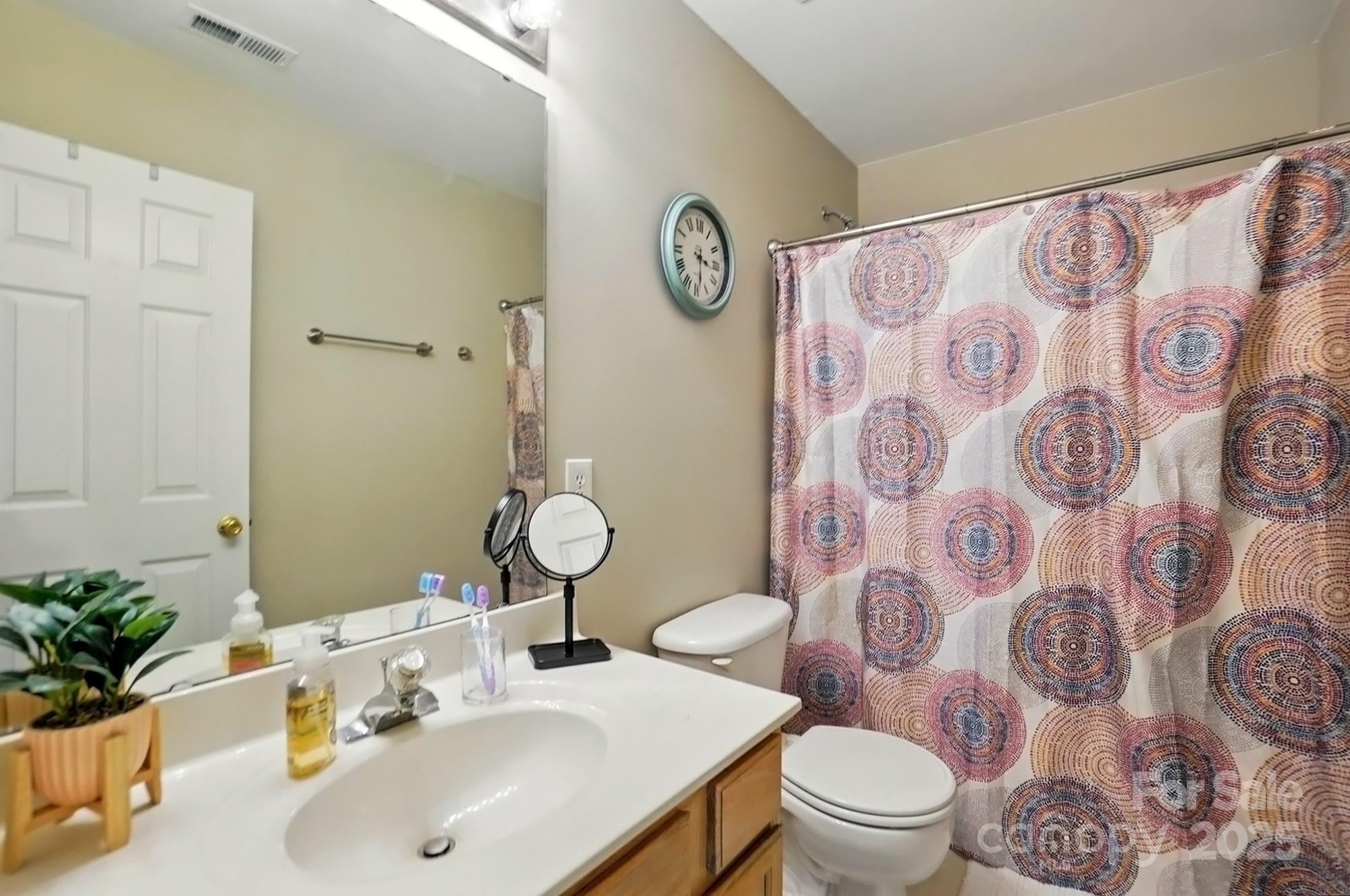 820 Settlement Street Clover, SC 29710 - Photo 21 of 29 a bathroom with a sink mirror vanity and toilet