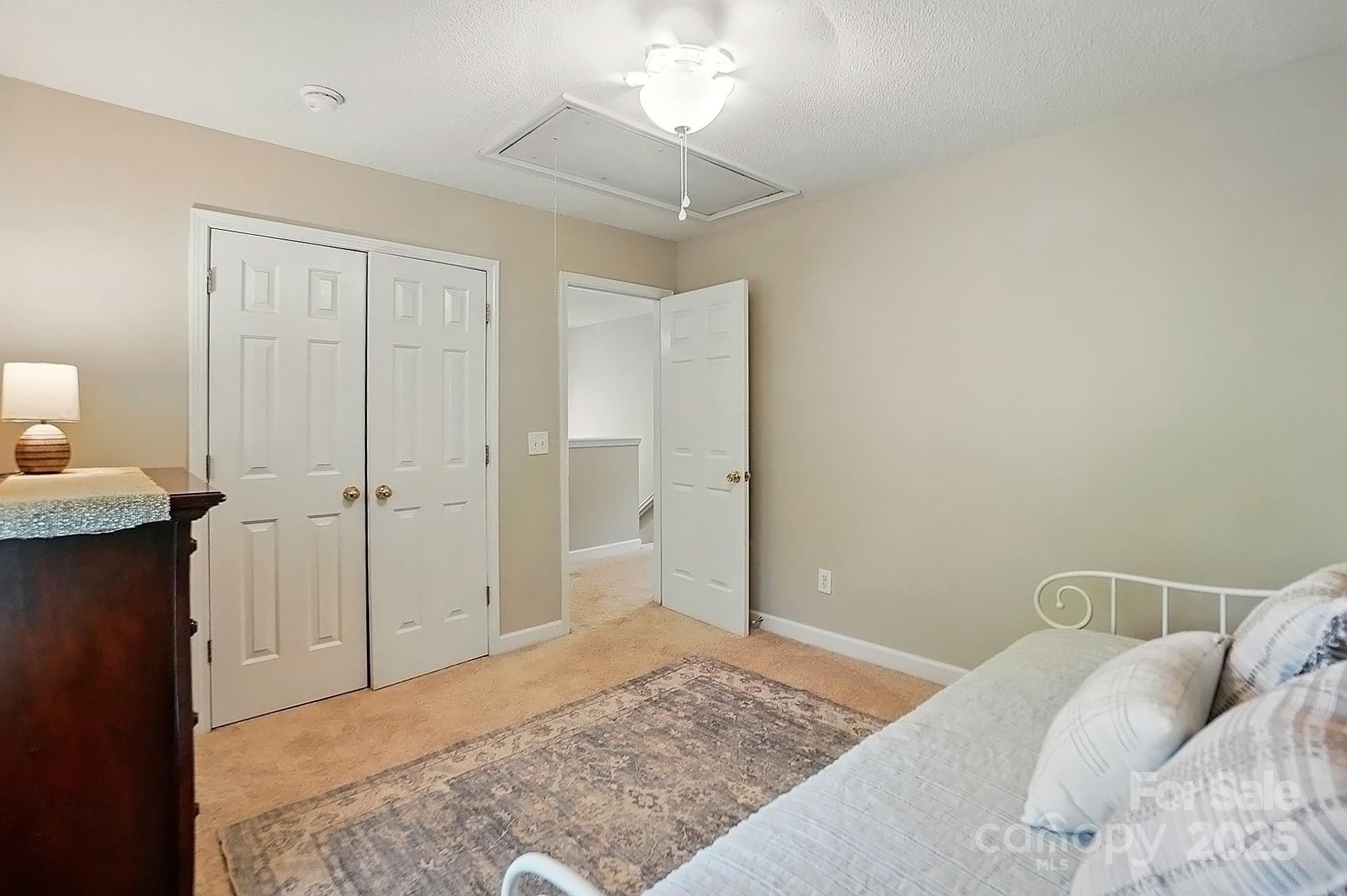 820 Settlement Street Clover, SC 29710 - Photo 23 of 29 a bedroom with a bed and a chandelier
