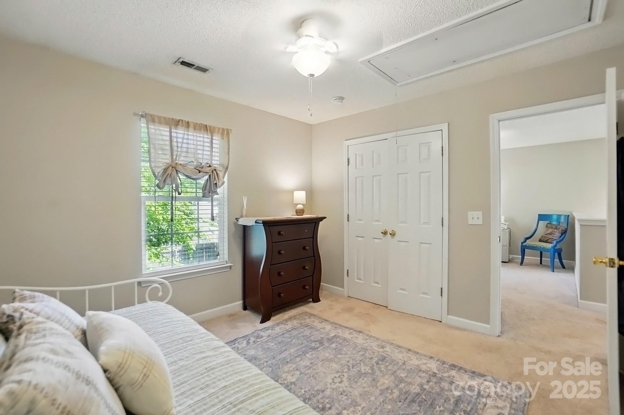 820 Settlement Street Clover, SC 29710 - Photo 24 of 29 a bedroom with a bed and a chandelier