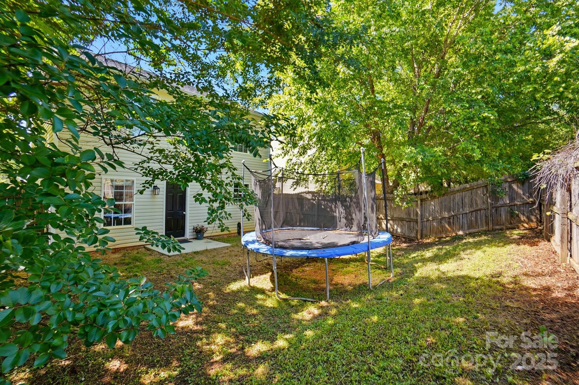 820 Settlement Street Clover, SC 29710 - Photo 29 of 29 a view of a backyard with table and chairs and wooden fence