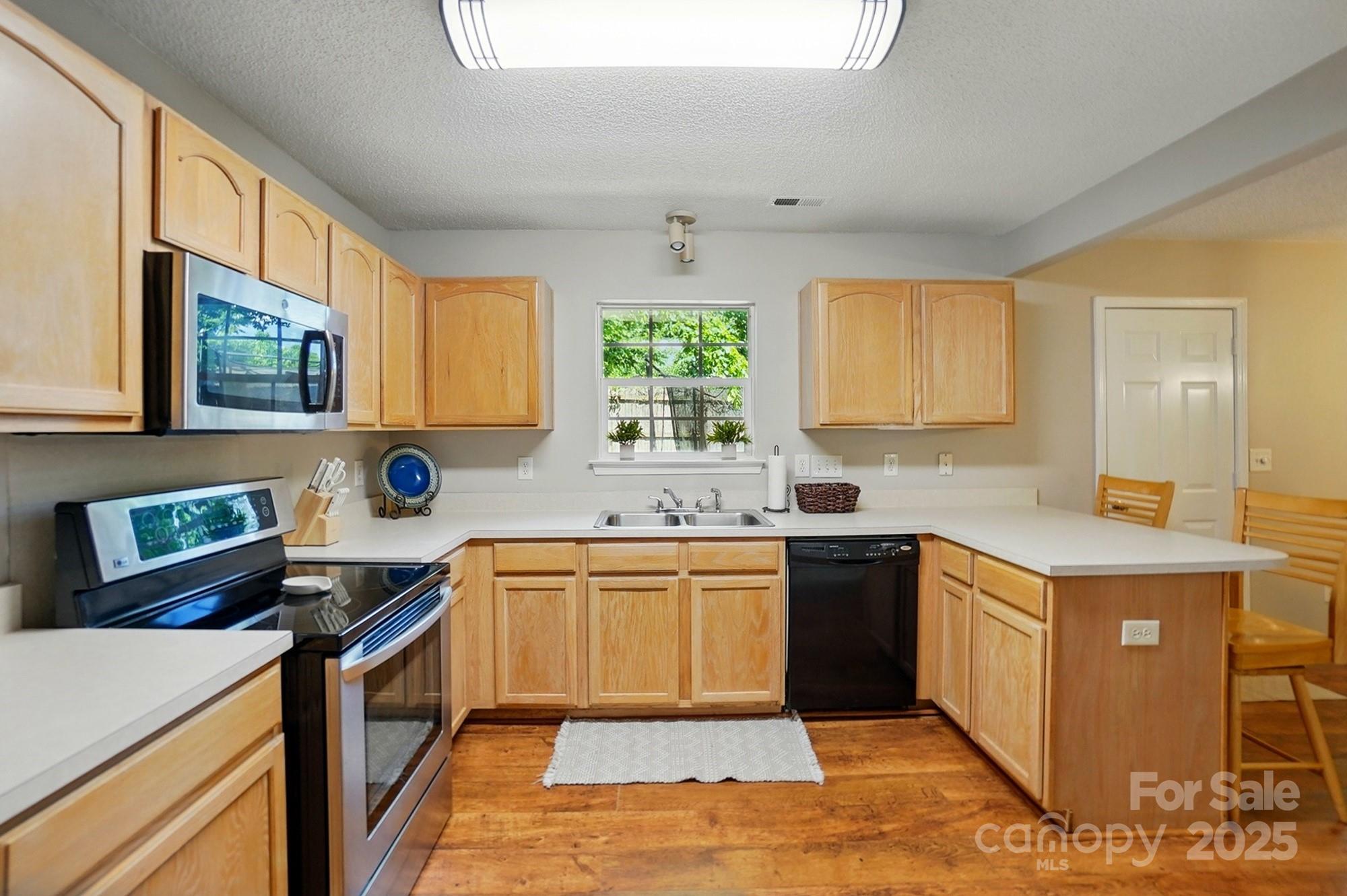 820 Settlement Street Clover, SC 29710 - Photo 6 of 29 a kitchen with a sink stove top oven and cabinets