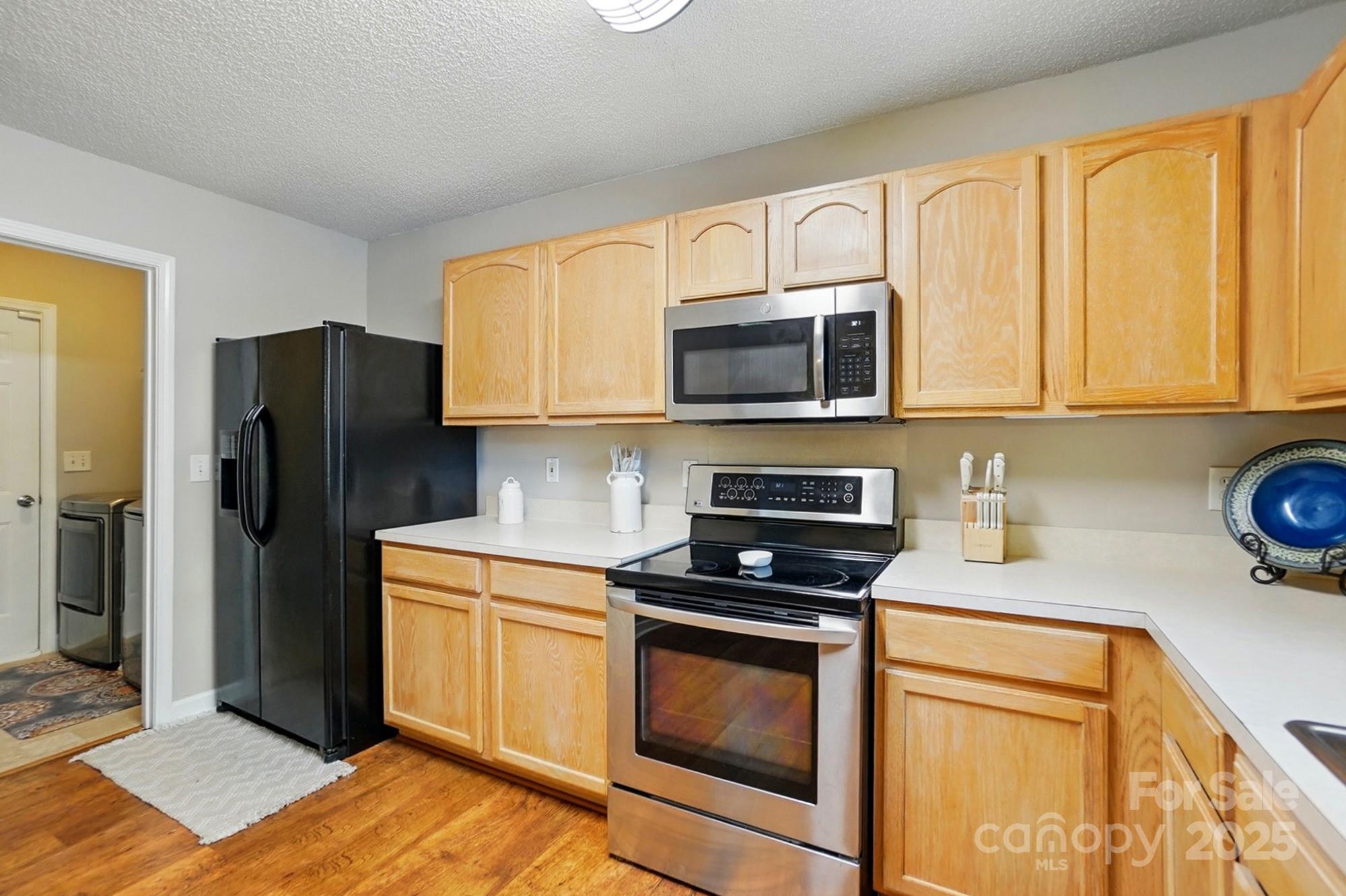 820 Settlement Street Clover, SC 29710 - Photo 7 of 29 a kitchen with granite countertop a refrigerator stove and microwave
