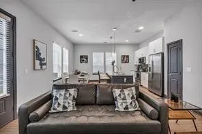 a living room with furniture window and a refrigerator