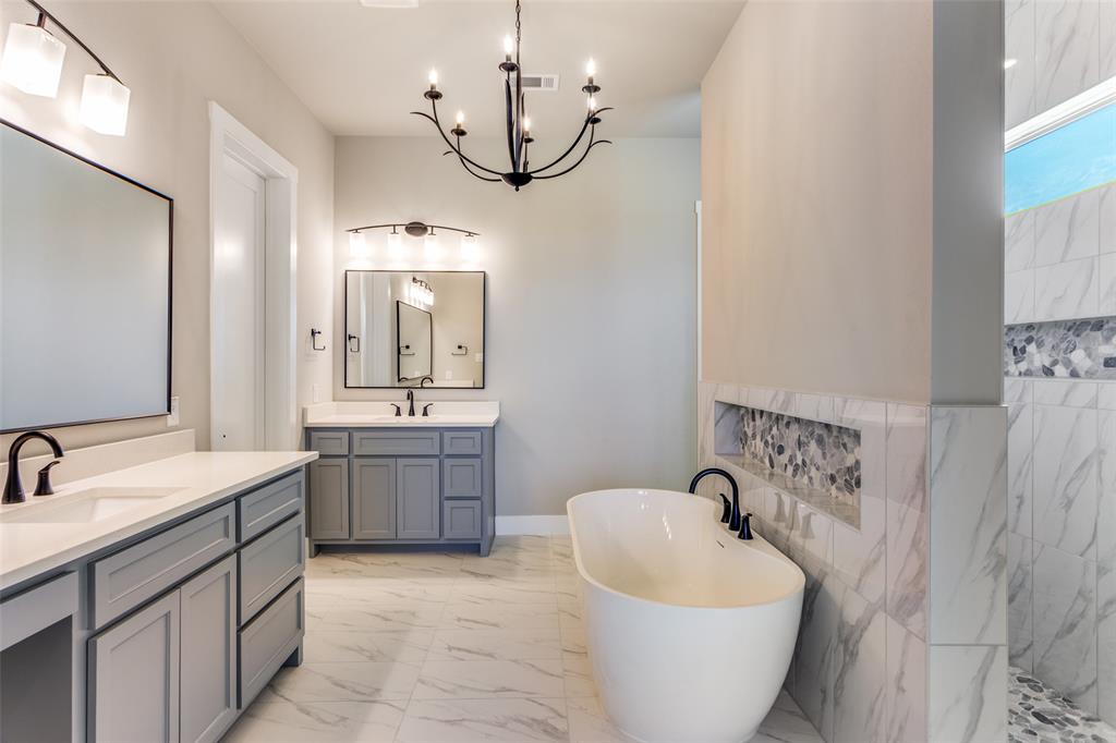 555 Aermotor Loop Weatherford, TX 76085 - Photo 27 of 30 a spacious bathroom with a bathtub sink and mirror