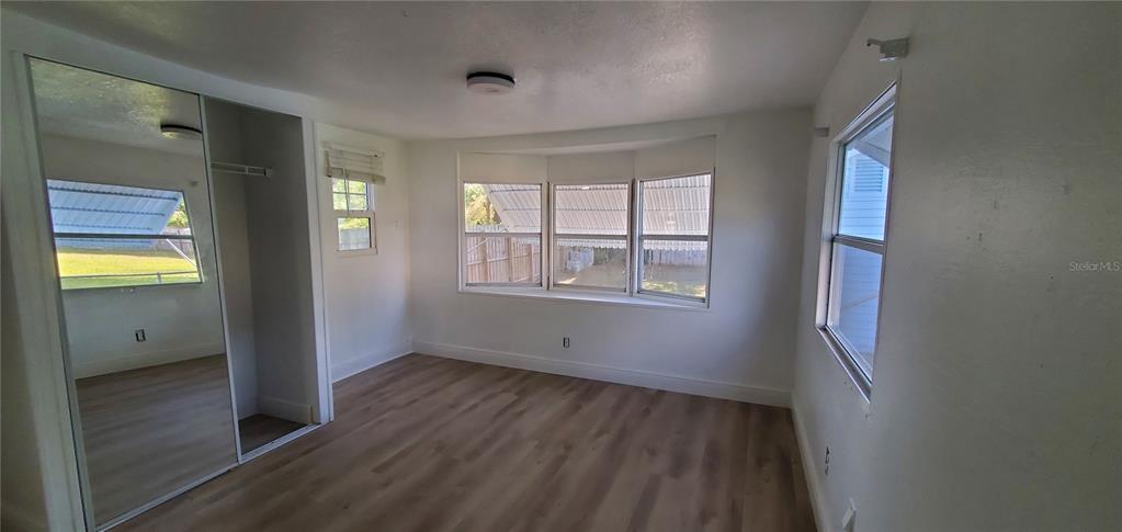 4305 Tony Street Orlando, FL 32808 - Photo 15 of 23 a view of an empty room with wooden floor and a window