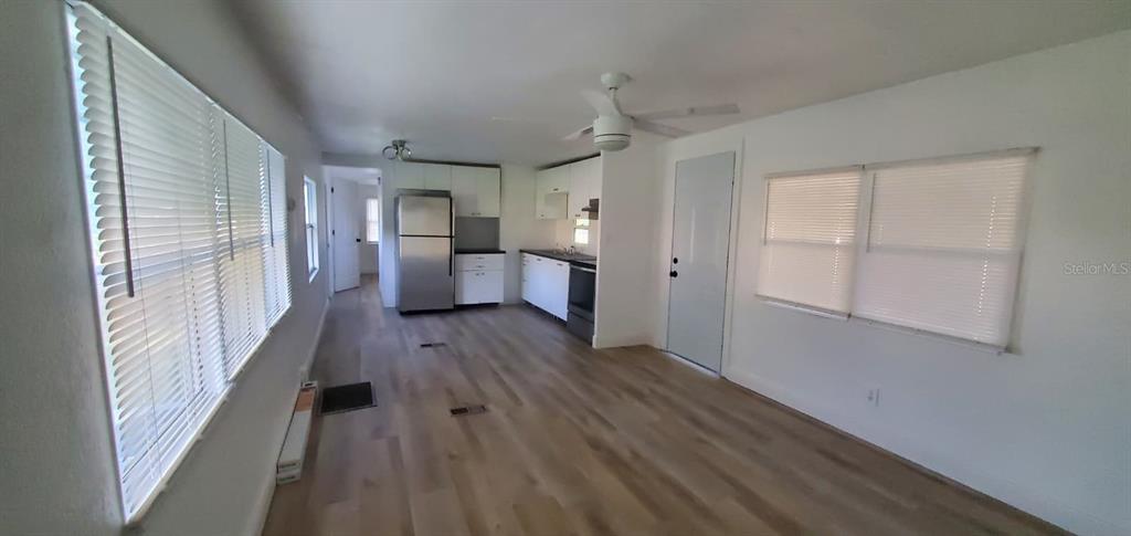 4305 Tony Street Orlando, FL 32808 - Photo 16 of 23 a view of a kitchen with a sink wooden floor and cabinets