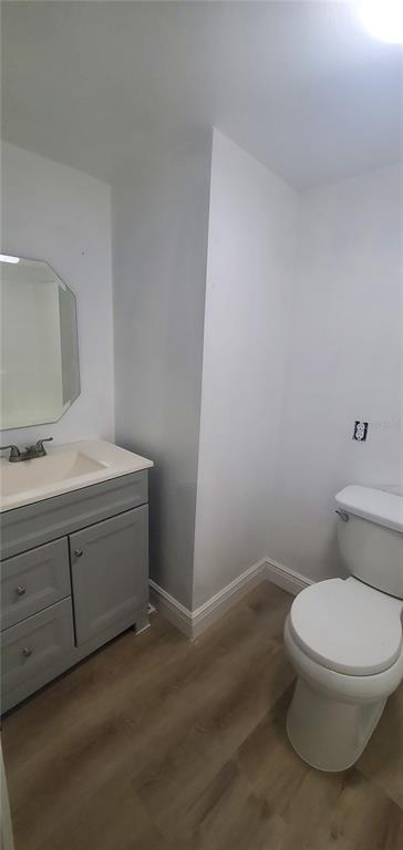 4305 Tony Street Orlando, FL 32808 - Photo 18 of 23 a bathroom with a toilet sink and vanity