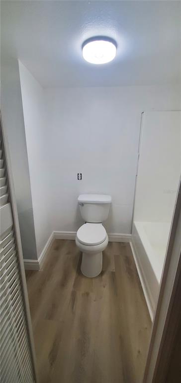 4305 Tony Street Orlando, FL 32808 - Photo 19 of 23 a bathroom with a toilet and a light fixture