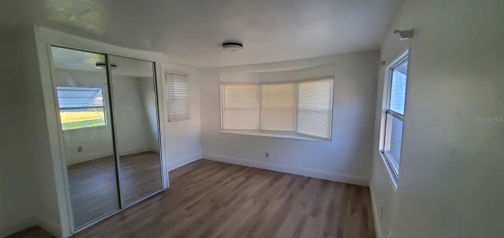 4305 Tony Street Orlando, FL 32808 - Photo 20 of 23 a view of an empty room with wooden floor and a window