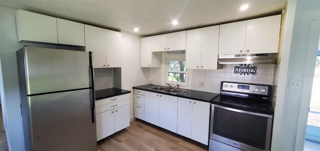 4305 Tony Street Orlando, FL 32808 - Photo 8 of 23 a kitchen with stainless steel appliances a refrigerator sink and stove