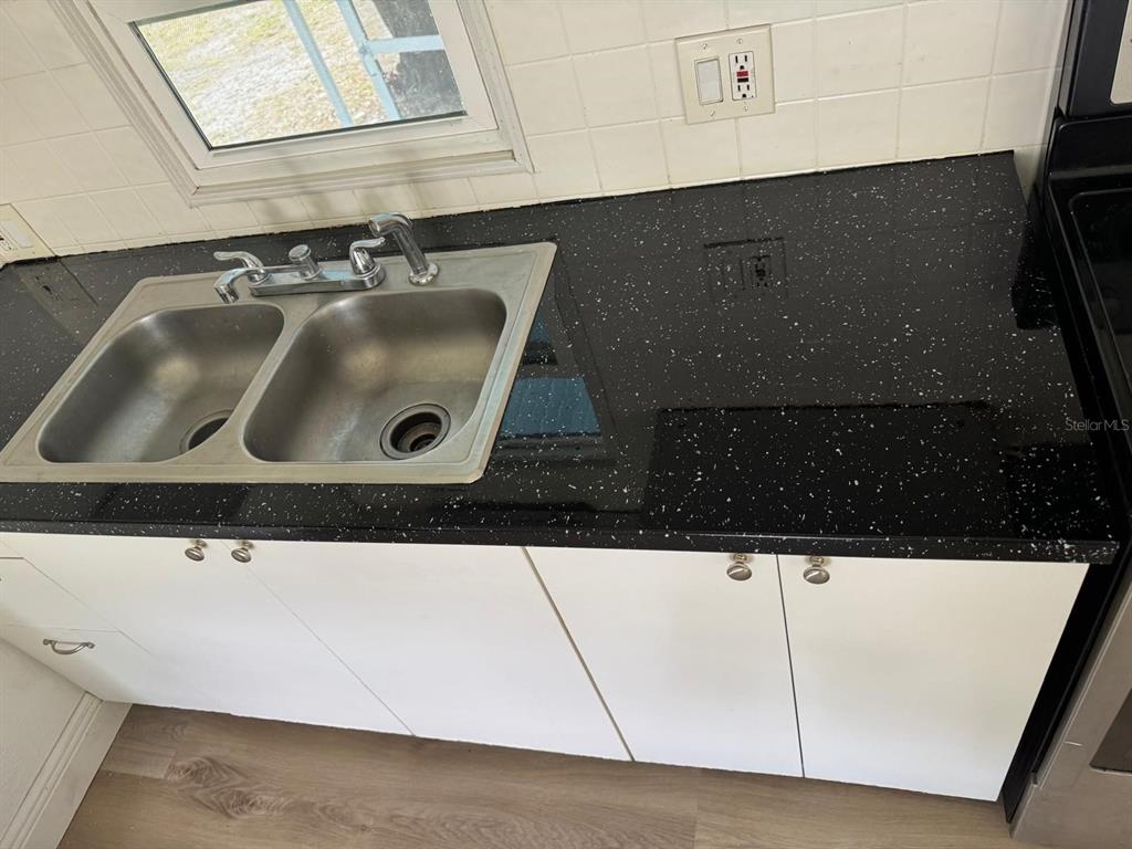 4305 Tony Street Orlando, FL 32808 - Photo 10 of 23 a bathroom with a sink and a mirror